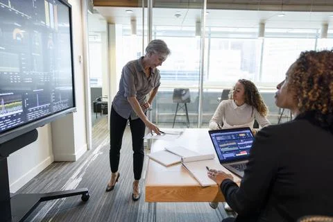 Project manager looking at document in team meeting Foto stock