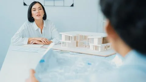 Project manager puts the map on table while discuss with coworker. Immaculate. Stock Photos