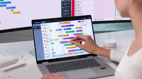 Project Manager Reviews Gantt Chart On Laptop Stock Footage 345330212