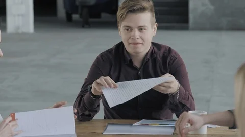 The project manager sits at a large table and listens to the proposals of Stock Footage 124551415