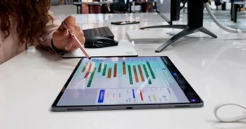 Project Manager Studies Detailed Digital Gantt Chart Schedule On Tablet. Stock Photos