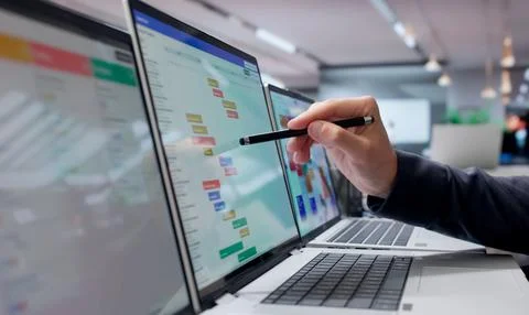 Project Manager Studies Project Timeline On Laptop During Busy Office Meeting Stock Photos