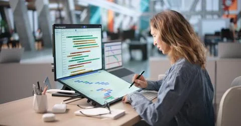 Project Manager Tracks Team Progress Using Digital Calendar And Touchscreen. Stock Photos