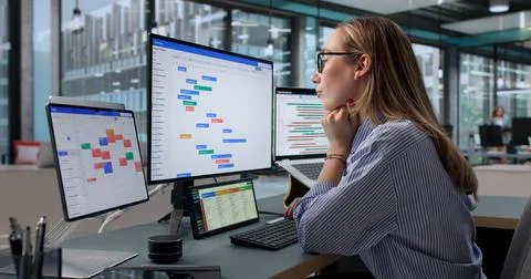 Project Manager Updates Agile Board While Planning Teams Workflow Schedule. Stock Photos