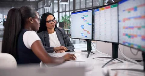 Project Manager Updates Team Schedule Using Colorful Gantt Chart Tools. Stock Photos