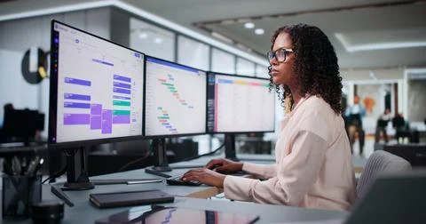 Project Manager Using Computer To Schedule Tasks On Office Calendar. Stock Photos