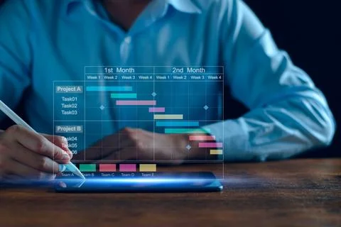 Project manager working on tablet and updating tasks and milestones progres.. Stock Photos
