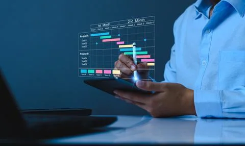Project manager working on tablet and updating tasks and milestones progres.. Stock Photos