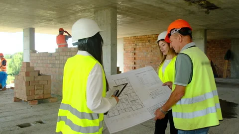 Project managers and builder discuss large floor plan Stock Footage 317610403