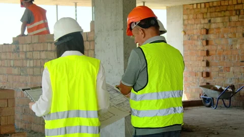 Project managers and worker look at layout studying features Stock Footage 317610622