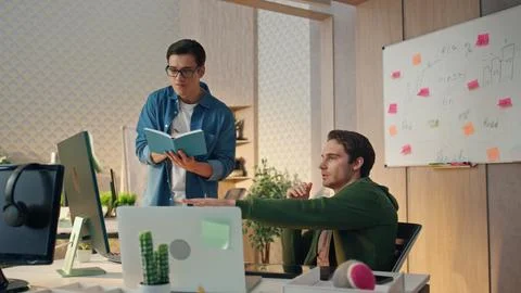 Project managers brainstorming computer at room. Colleagues discussing at office Stock Photos