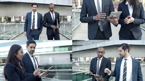 Project managers discussing and watching presentation on tablet Stock Footage 130018004