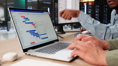 Project Managers Review Gantt Chart Schedules Together Stock Footage 334922353