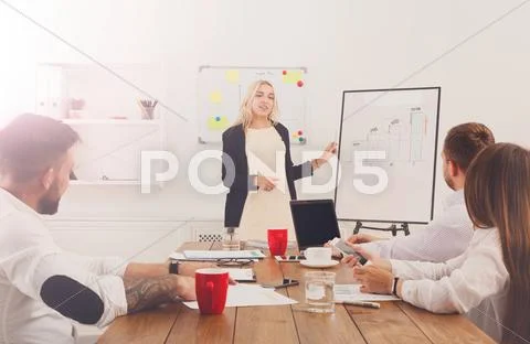 Project presentation. Young hipsters businessmen and women at mo Stock Photos