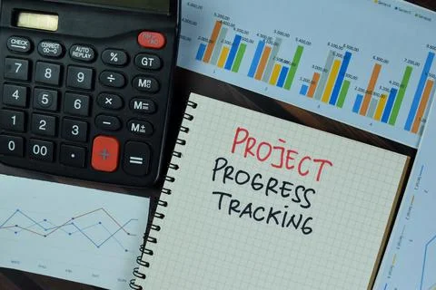 Project Progress Tracking write on a book isolated on Wooden Table. Stock Photos
