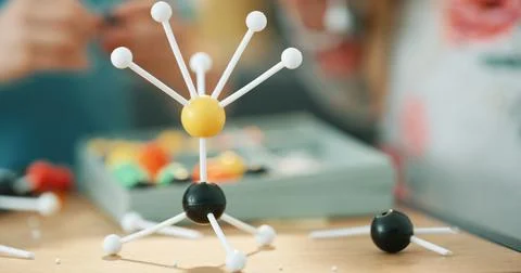 Project, science and person with atom model on desk for studying, education.. Stock Photos