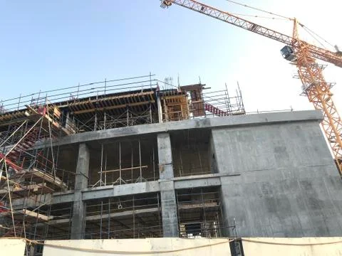 Project Site Construction under progress using tower crane and activities lik Stock Photos