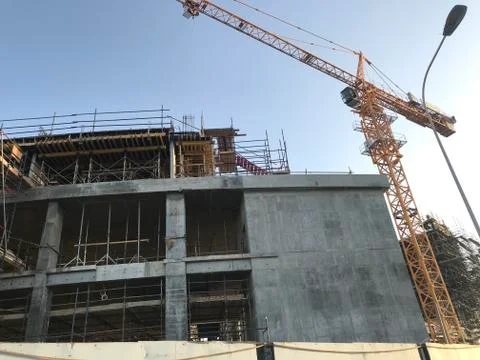 Project Site Construction under progress using tower crane and activities lik Stock Photos