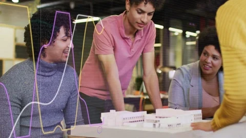 Project team leaning around white model as host moving parts, discussing layout Stock Footage 333485420