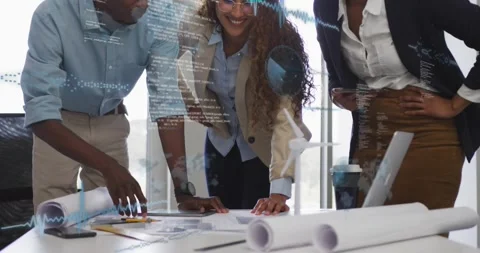 Project team leaning over table pointing and touching plans, showing data Stock Footage 321412499
