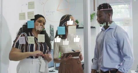 Project team tapping tablet screen and sketching pie chart on glass partition Stock Footage 312844461