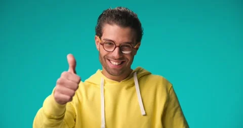 Project video of smart young man with glasses pointing fingers to head, smiling Stock Footage 230127401