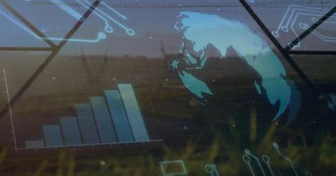 Projecting digital interface over grassland, showing globe, rising bar chart and Stock Photos