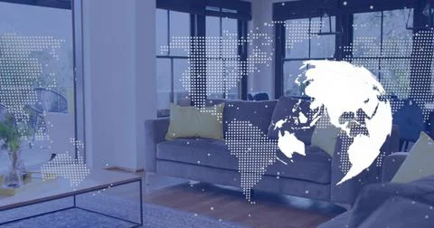 Projecting globe graphic across mid-gray sofa with yellow pillows in living Stock Photos