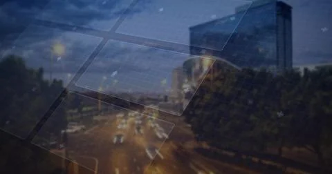Projecting grid panels overlaying nighttime street, with light trails, trees and Stock Photos