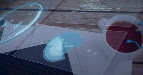 Projecting holographic circular interface hovering above tablet at wooden desk, Stock Photos
