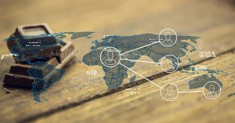 Projecting thin world map overlay across wood table, with dark chocolate stack 스톡 사진