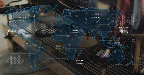 Projecting translucent blue world map overlay over office desk, showing laptop Stockfoto's