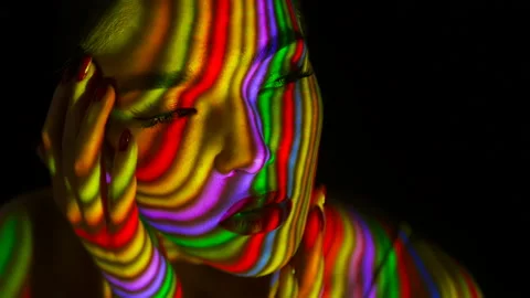 Projection of the multicolored lines on face and body of the girl. Stock Footage 104213440