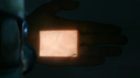 Projector with beam of light on hand Stock Footage 64098675