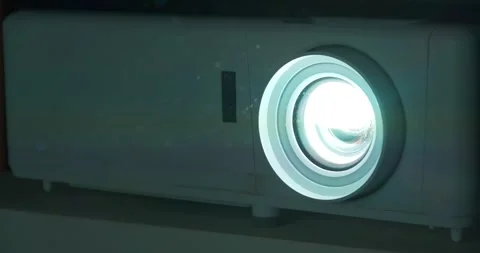 Projector lens. Dust near projector in cinema hall is visible in rays of light Stock Footage 280042024