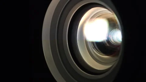 Projector lens in operation close-up. Lenses of working projector change color Stock Footage 278984498