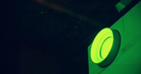 Projector lens in operation. Dust in cinema hall is visible in green light rays Stock Footage 278618038