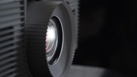 The projector shines through the dust motes floating in the air. Stock Footage 144350069