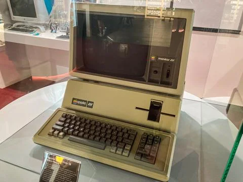 Prominently displayed vintage Apple computer in a museum or exhibition, encas Stock Photos