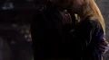 Promiscuous smoking girl teasing handsome male, kissing him at nightclub party HD Footage