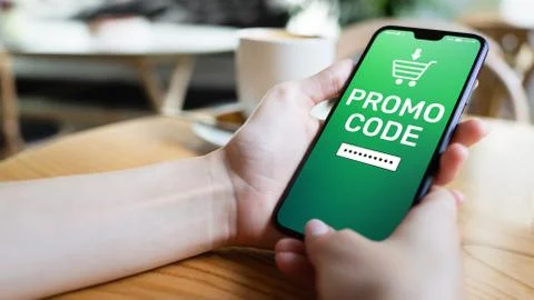 Promo code Discount coupon number field on mobile phone screen. Business and Stock Photos