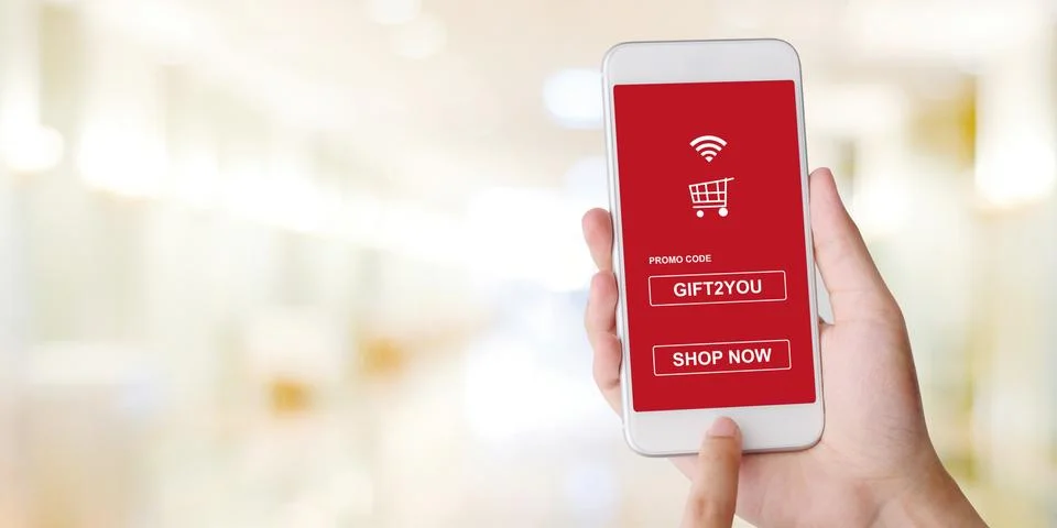 Promo code on mobile phone screen for shopping online discount, Hand holding Stock Photos