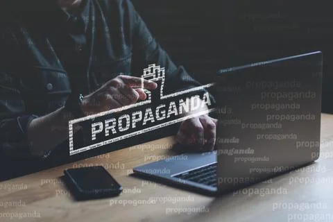 Propaganda visual concept. Man points finger at Propaganda text Stock Photos