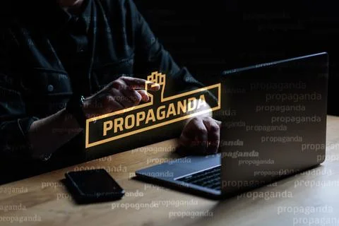 Propaganda visual concept. Man points finger at Propaganda text Stock Photos