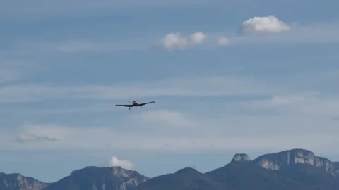 Propeller airplane flies over Alpine meadow Stock-Footage 252736121