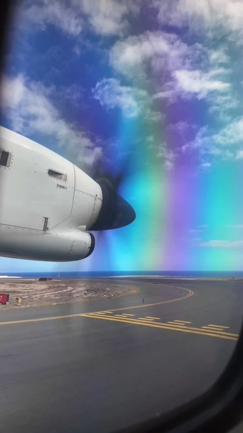 Propeller airplane moving on the runway with a rainbow effect 库存影片 345362253