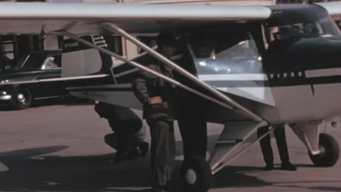 Propeller plane being checked by pilots before flight. 1950s digitalized video Stock Footage 168884459