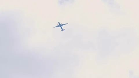 Propeller plane flies out of the clouds Stock Footage 77076743