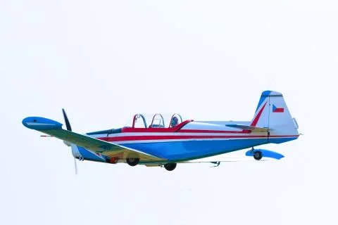 Propeller plane in flight in sky in sunny day, Prague Stock Photos