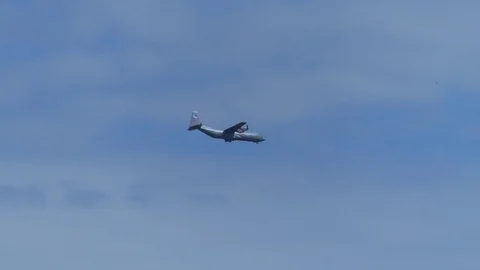 Propeller plane flying in a blue sky with clouds. Descending airplane footage. Stock Footage 76773895